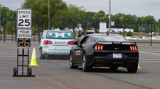 A black Ford Mustang approaches the Balloon Car, displaying the automatic braking feature.